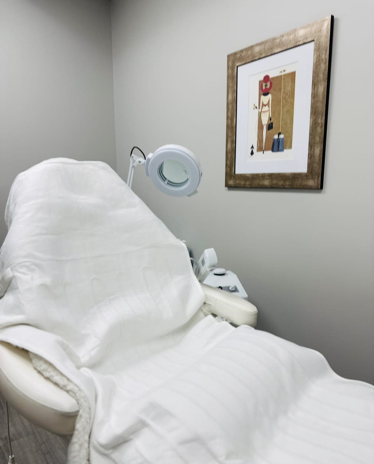 Esthetician treatment room with white linens